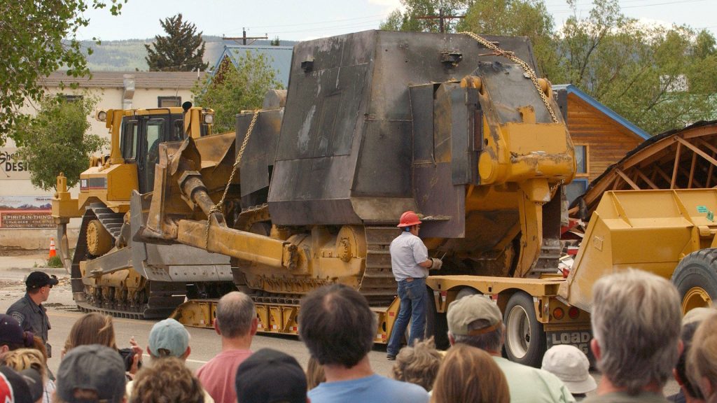 A ridiculously covered bulldozer, nicknamed Killdozer, where the cabin has been covered in plate steel and concrete as it makes its way to its intended targets.